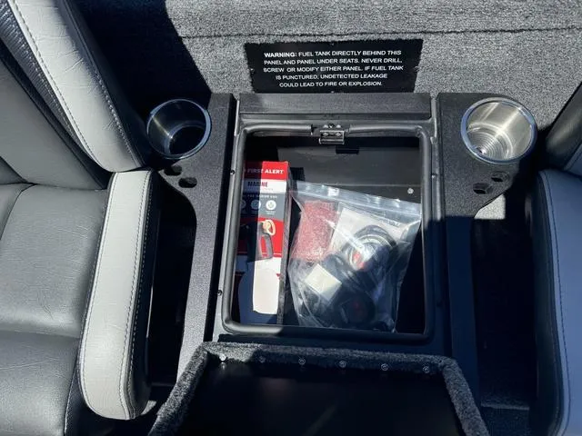 Slide: The Image of Storage compartment in 2025 Phoenix Bass Boats 721 ZXL with safety equipment and cup holders. - 27