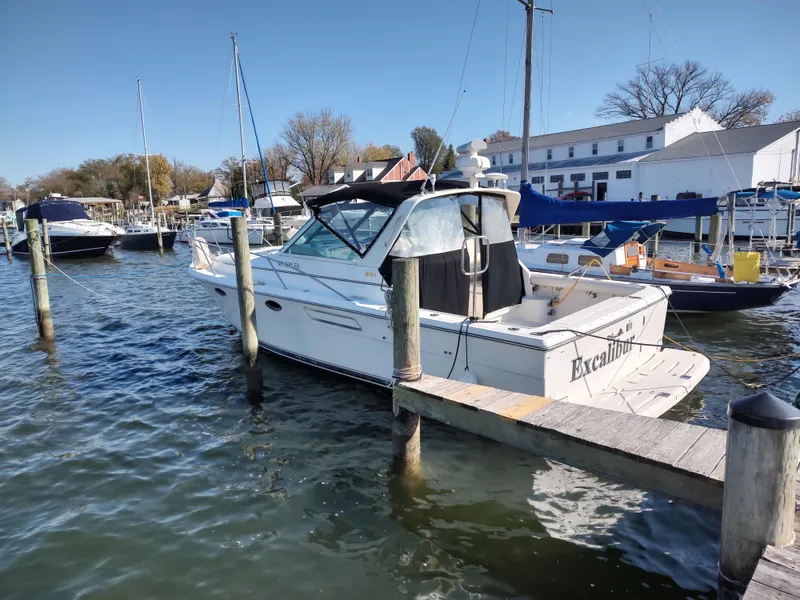 Slide: The Image of 1994 Tiara Yachts 3100 Open docked at a marina on a sunny day. - 0