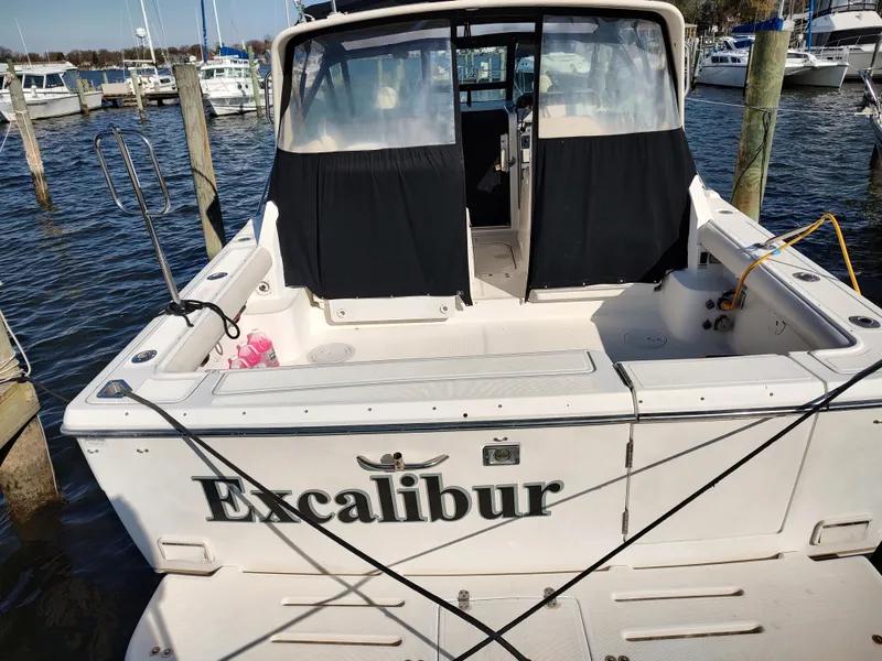 Slide: The Image of 1994 Tiara Yachts 3100 Open named Excalibur docked at a marina. - 1