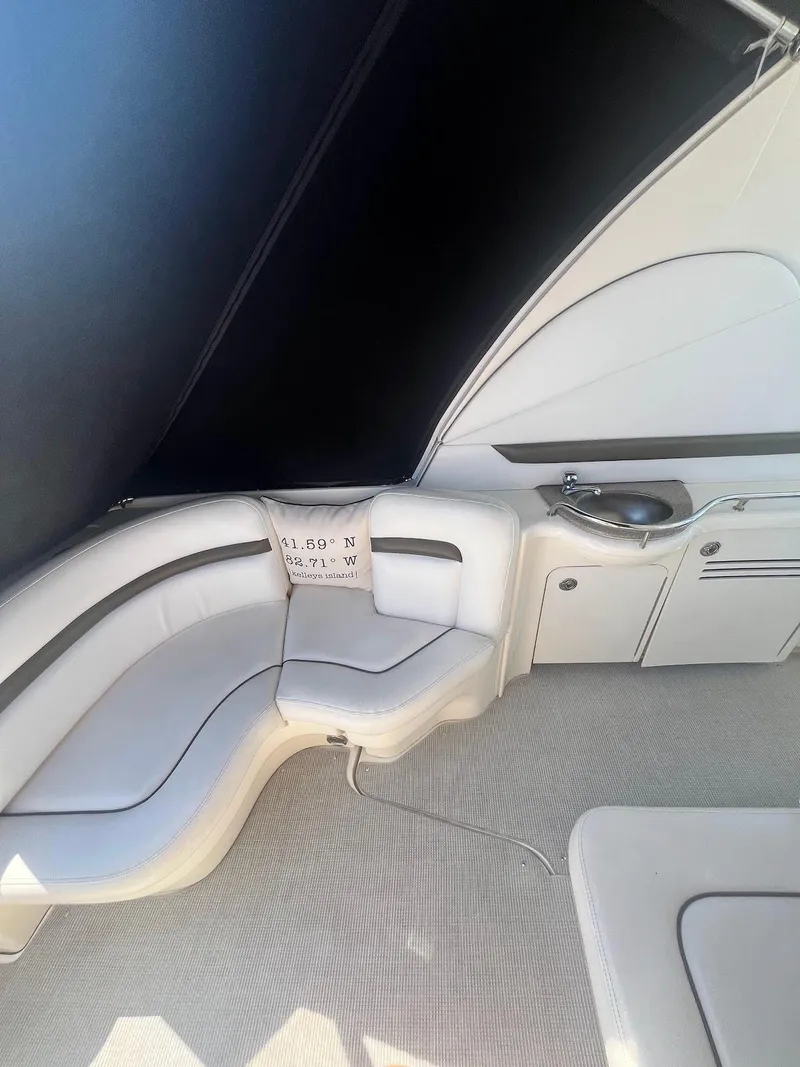 Slide: The Image of 2006 Sea Ray 38 Sundancer interior seating area with white upholstery. - 11