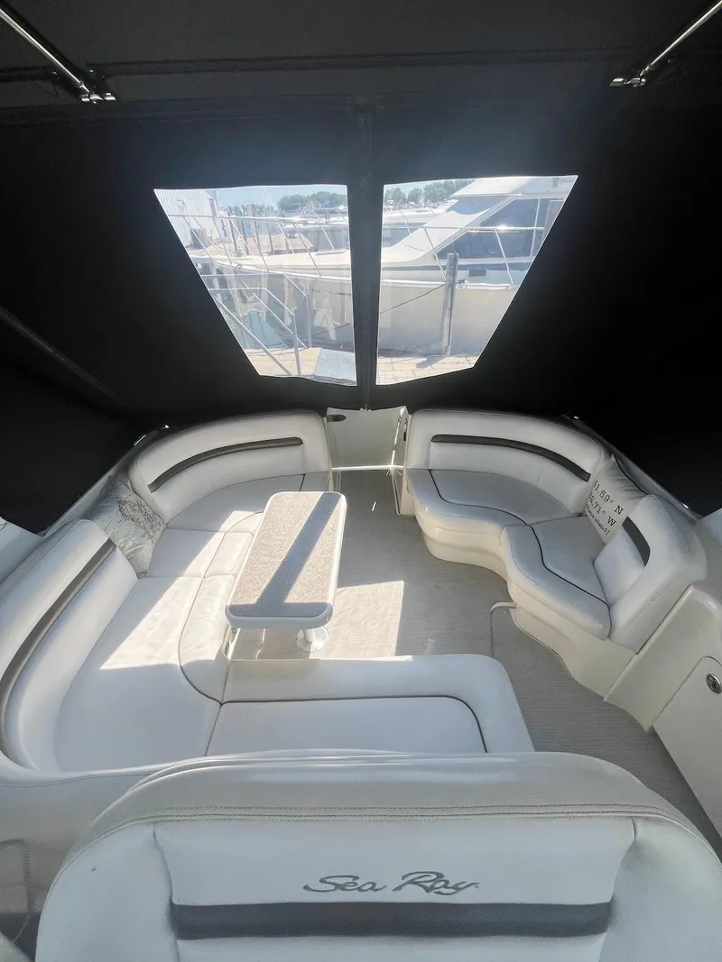 Slide: The Image of 2006 Sea Ray 38 Sundancer interior with spacious seating and table. - 12