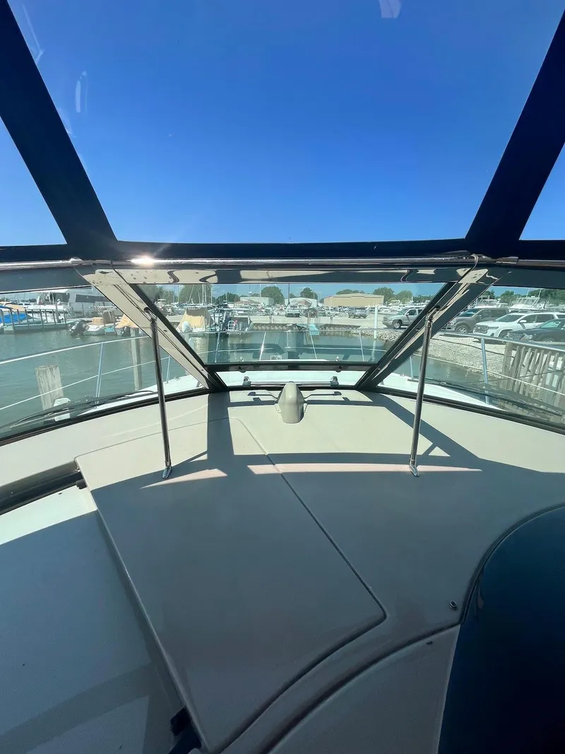 Slide: The Image of View from the helm of a 2006 Sea Ray 38 Sundancer yacht at a marina. - 13