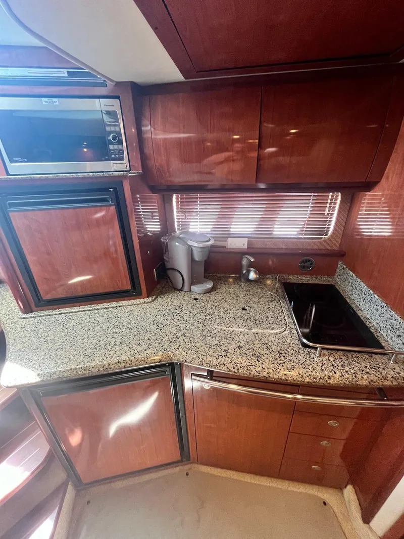 Slide: The Image of Interior kitchen of 2006 Sea Ray 38 Sundancer yacht with granite countertops. - 14