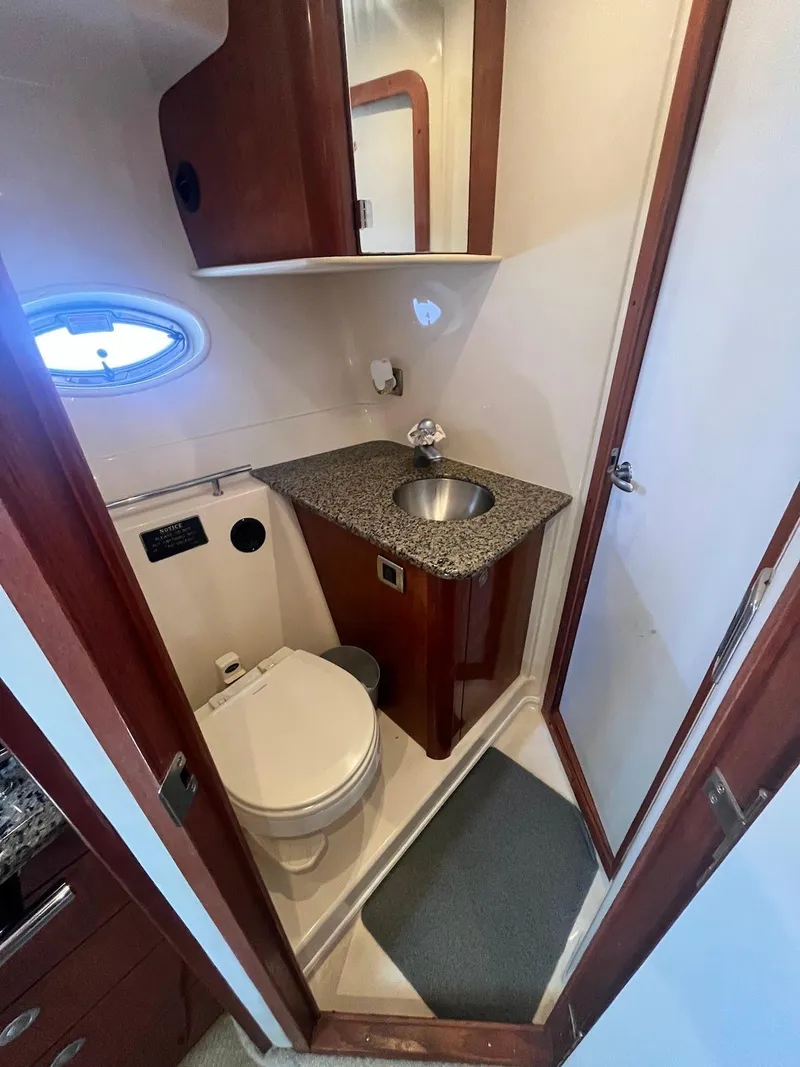 Slide: The Image of 2006 Sea Ray 38 Sundancer bathroom with granite countertop, sink, and toilet. - 15