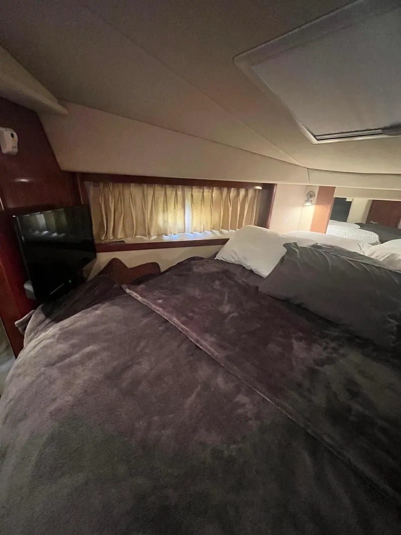 Slide: The Image of Interior cabin of a 2006 Sea Ray 38 Sundancer yacht with cozy bedding. - 18
