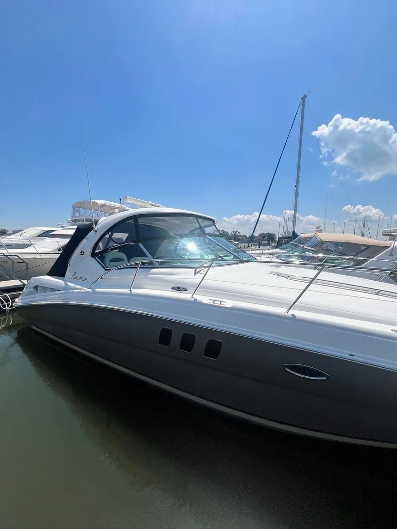 Slide: The Image of 2006 Sea Ray 38 Sundancer yacht docked at marina under clear blue sky. - 2