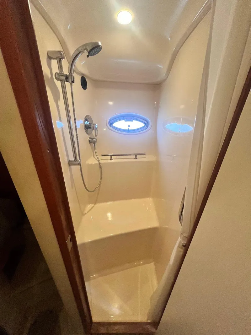 Slide: The Image of 2006 Sea Ray 38 Sundancer shower with porthole and modern fixtures. - 20