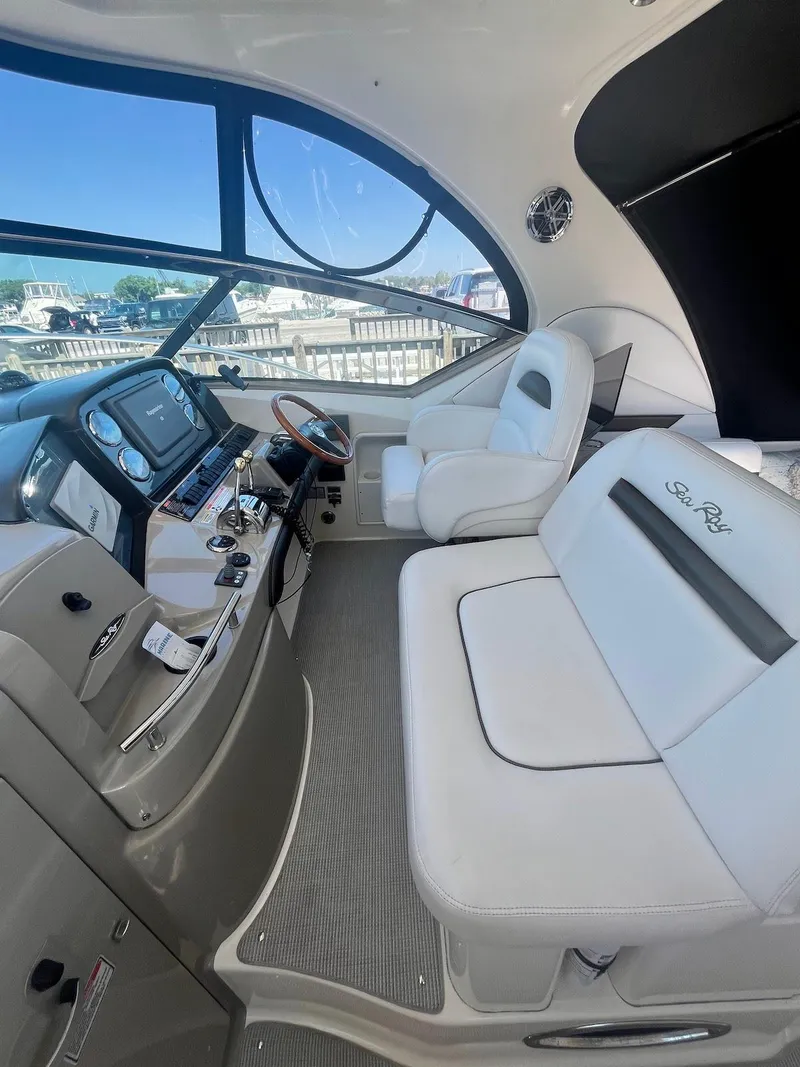 Slide: The Image of Interior cockpit of a 2006 Sea Ray 38 Sundancer yacht with white leather seating. - 6