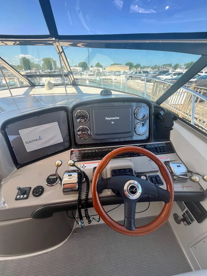 Slide: The Image of Helm of 2006 Sea Ray 38 Sundancer with Raymarine electronics and wooden steering wheel. - 7