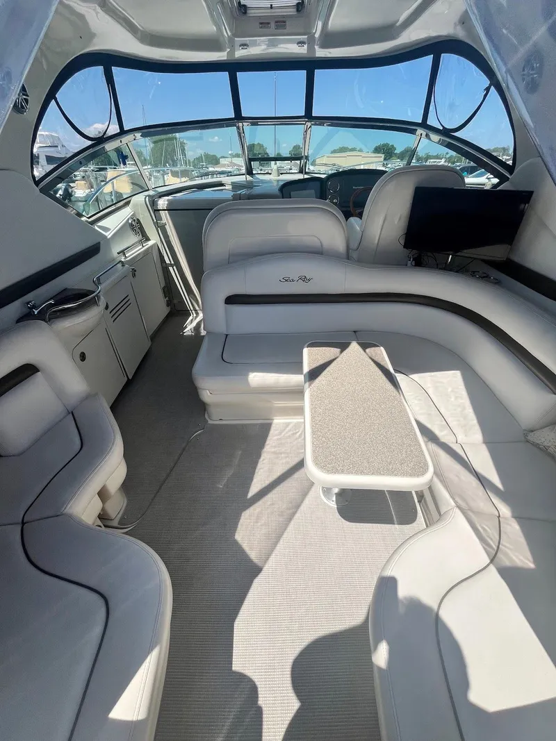 Slide: The Image of Interior of 2006 Sea Ray 38 Sundancer yacht with white seating and table. - 9