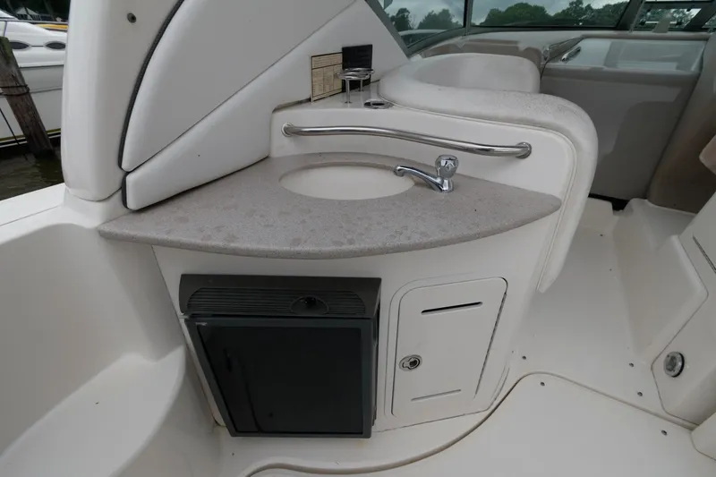 Slide: The Image of 2006 Sea Ray 320 Sundancer boat interior with sink and storage. - 10