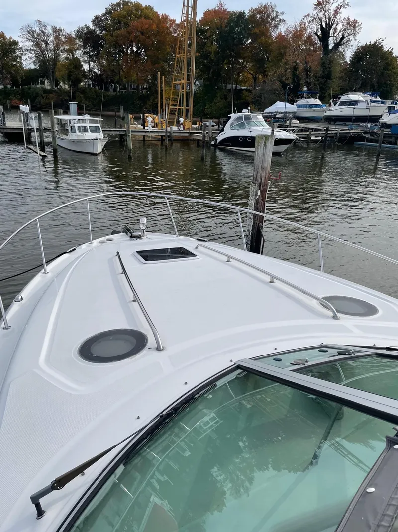 Slide: The Image of 2006 Sea Ray 320 Sundancer docked at a marina with other boats. - 4