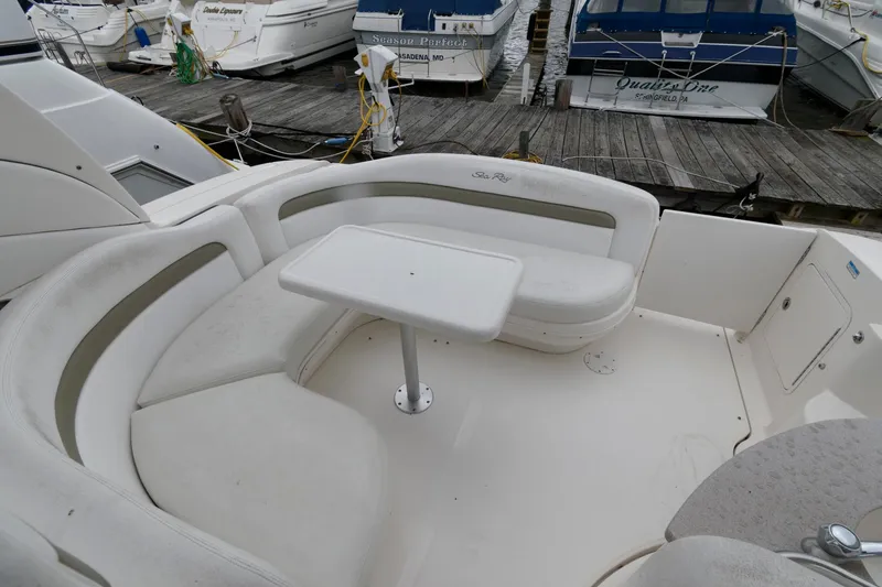 Slide: The Image of 2006 Sea Ray 320 Sundancer boat seating area with table at marina. - 6