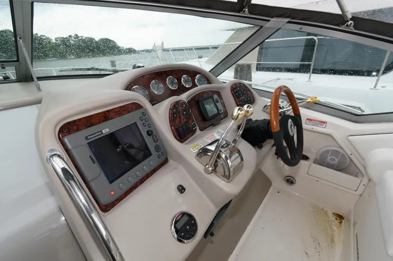 Slide: The Image of 2006 Sea Ray 320 Sundancer helm with navigation system and controls. - 7