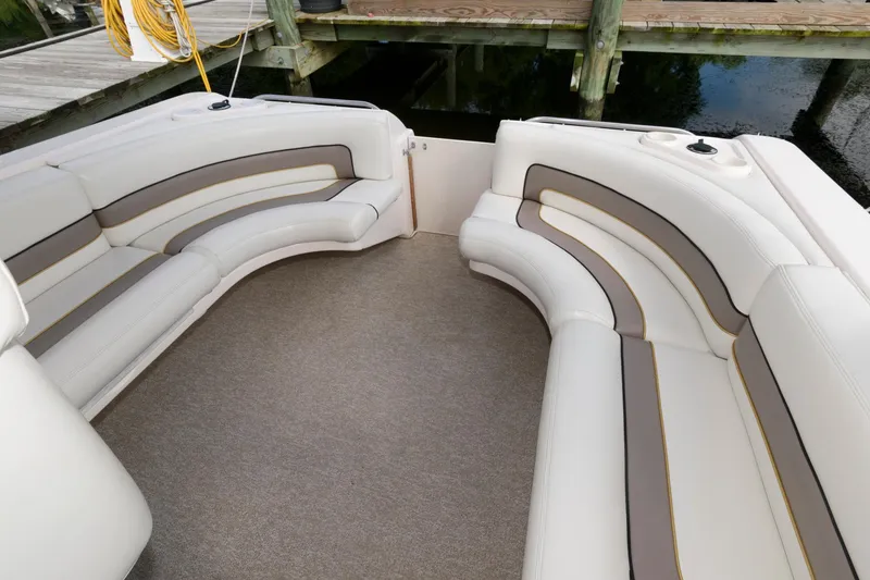 Slide: The Image of 1997 Donzi 3250 LXC boat interior with curved seating and neutral upholstery. - 10