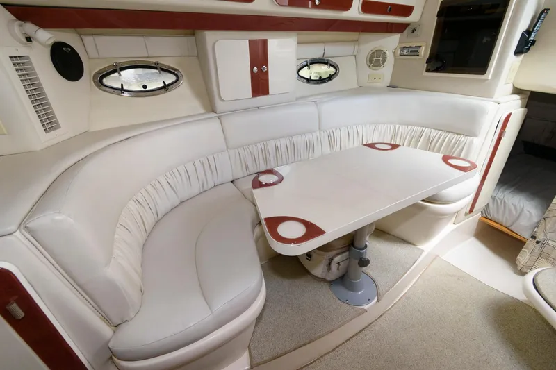 Slide: The Image of Interior of a 1997 Donzi 3250 LXC boat with white seating and table. - 13