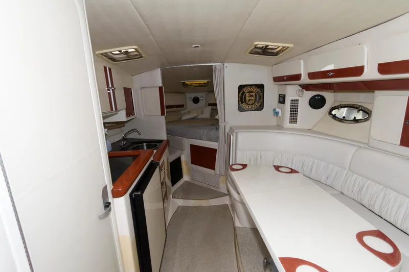 Slide: The Image of Interior of 1997 Donzi 3250 LXC boat with kitchenette and seating area. - 17