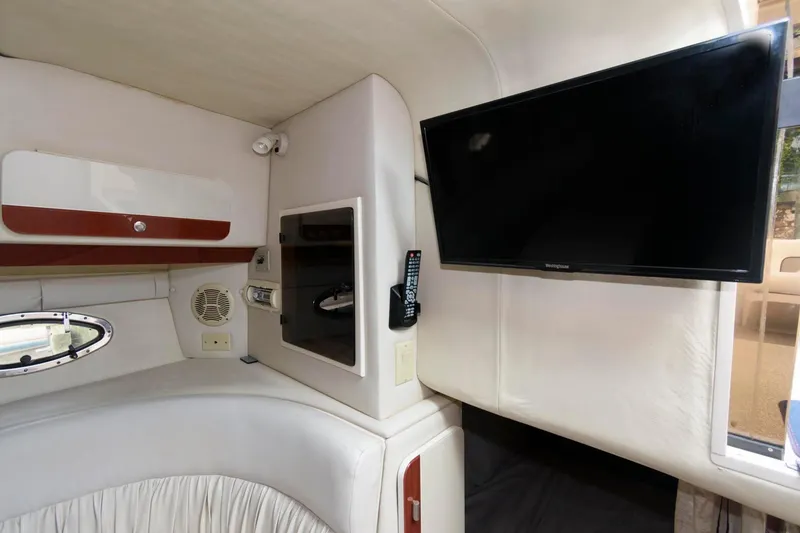 Slide: The Image of Interior of 1997 Donzi 3250 LXC boat with TV and storage compartments. - 19