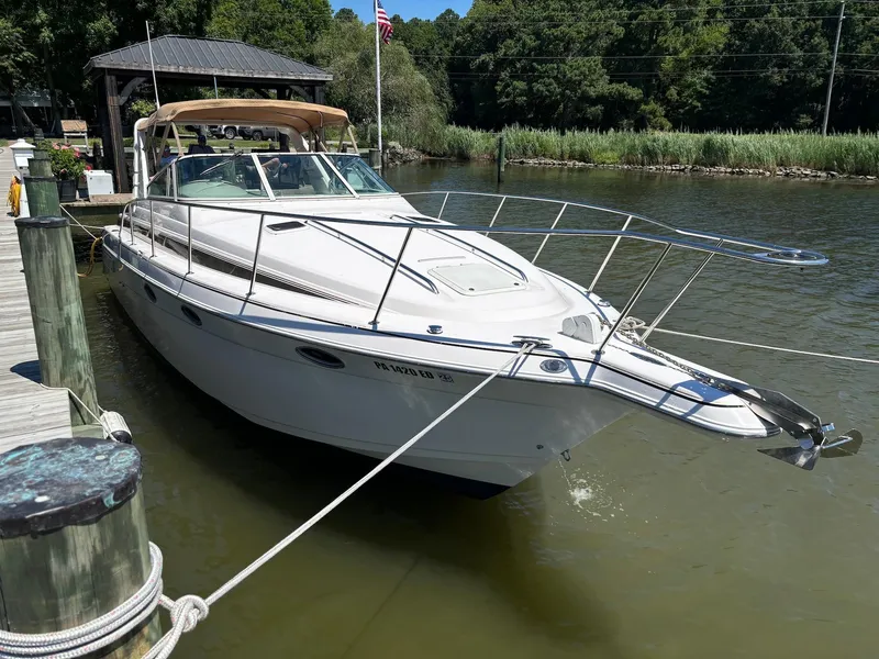 Slide: The Image of 1997 Donzi 3250 LXC boat docked at a marina. - 3