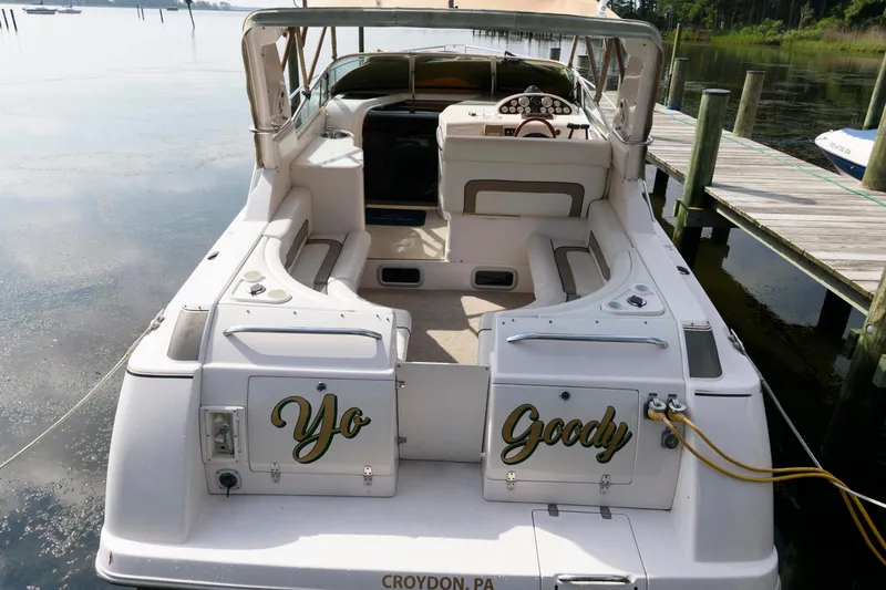 Slide: The Image of 1997 Donzi 3250 LXC boat docked, rear view with "Yo Goody" text. - 4