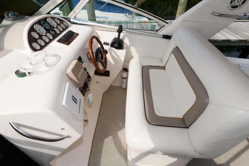 Slide: The Image of 1997 Donzi 3250 LXC boat interior with white seating and control panel. - 5