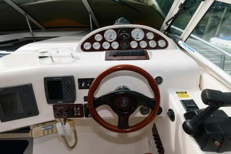Slide: The Image of 1997 Donzi 3250 LXC boat dashboard with steering wheel and navigation instruments. - 7