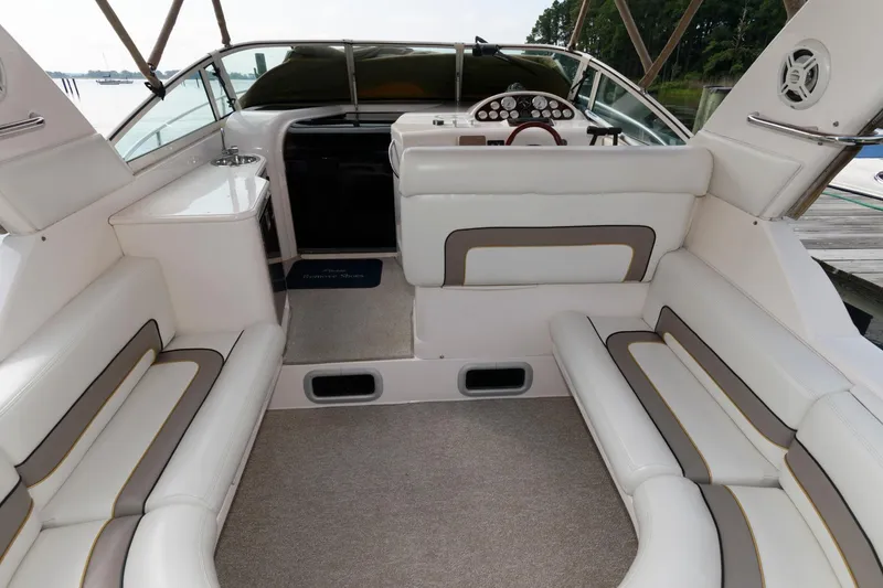 Slide: The Image of 1997 Donzi 3250 LXC boat interior with white seating and dashboard. - 8