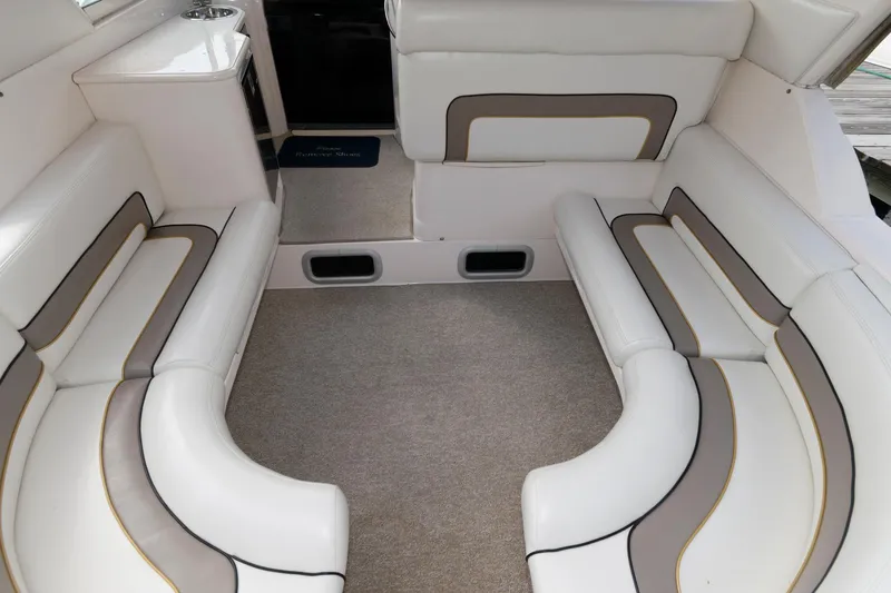 Slide: The Image of 1997 Donzi 3250 LXC boat interior with white and gray seating. - 9