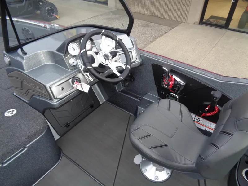 Slide: The Image of 2024 Nitro ZV21 Pro boat interior with steering wheel and captain's chair. - 11
