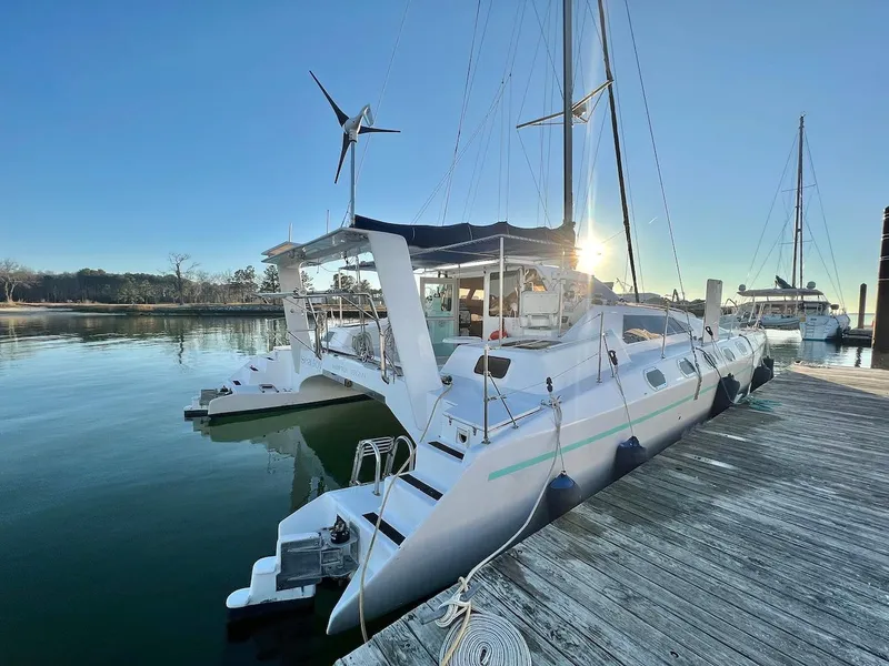 Slide: The Image of 2007 Farrier F-41 catamaran docked at a marina with clear skies. - 0
