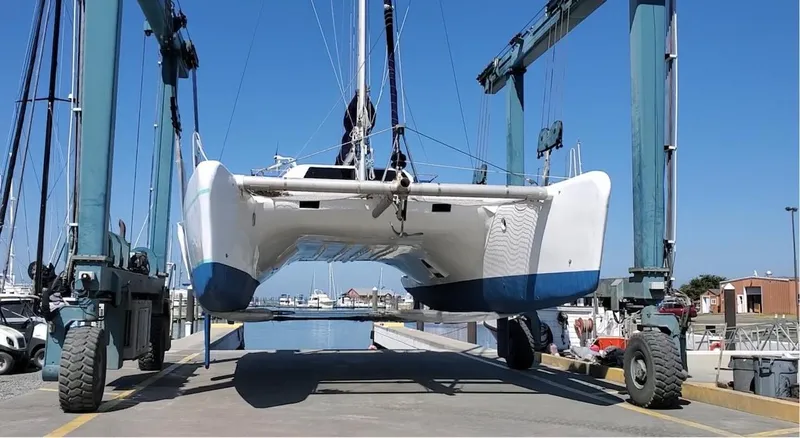 Slide: The Image of Catamaran Farrier F-41 2007 being lifted by a boat hoist at a marina. - 1