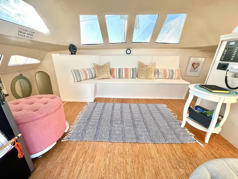 Slide: The Image of Interior of 2007 Farrier F-41 sailboat with cozy seating, striped cushions, and decorative rug. - 12