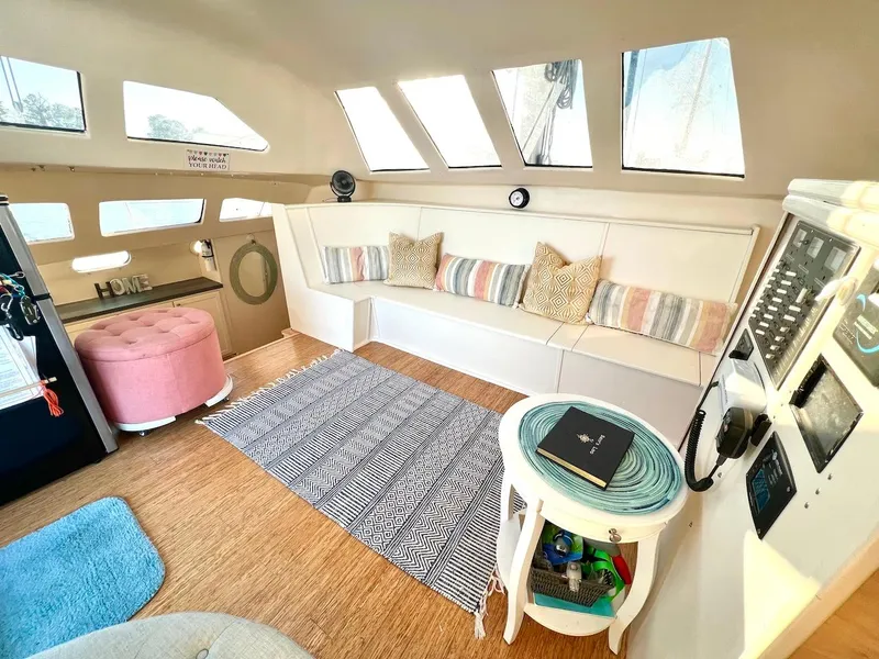 Slide: The Image of Interior of 2007 Farrier F-41 catamaran with cozy seating and nautical decor. - 13
