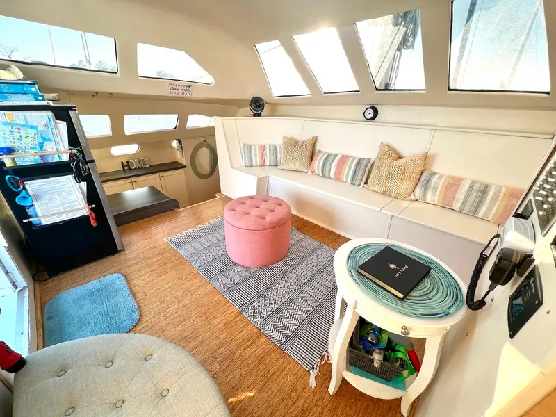 Slide: The Image of 2007 Farrier F-41 yacht interior with cozy seating, pink ottoman, and nautical decor. - 14
