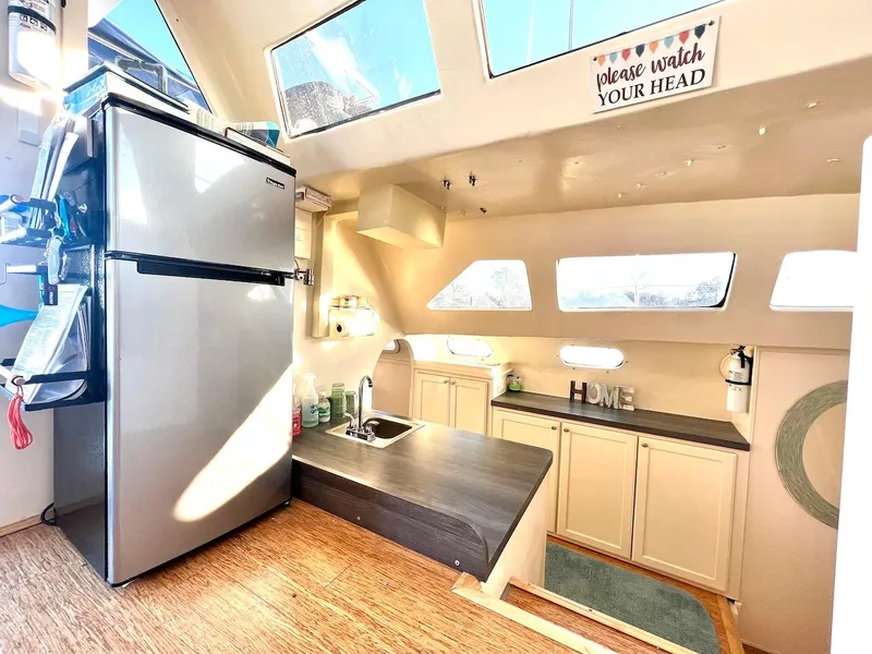 Slide: The Image of 2007 Farrier F-41 interior kitchen with stainless steel fridge, sink, and cabinets. - 16