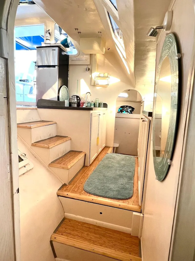 Slide: The Image of Interior of 2007 Farrier F-41 sailboat with wooden steps and compact kitchen area. - 18
