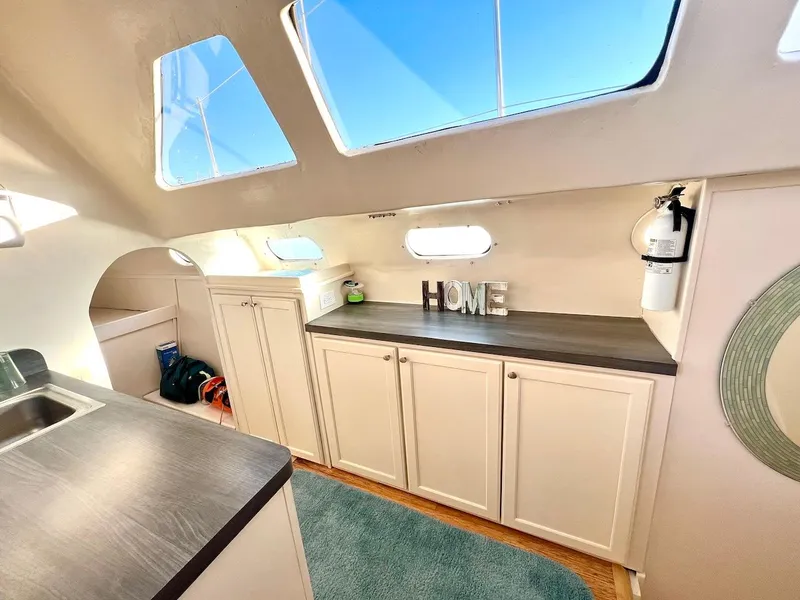 Slide: The Image of Interior of 2007 Farrier F-41 catamaran with modern cabinetry and large windows. - 21