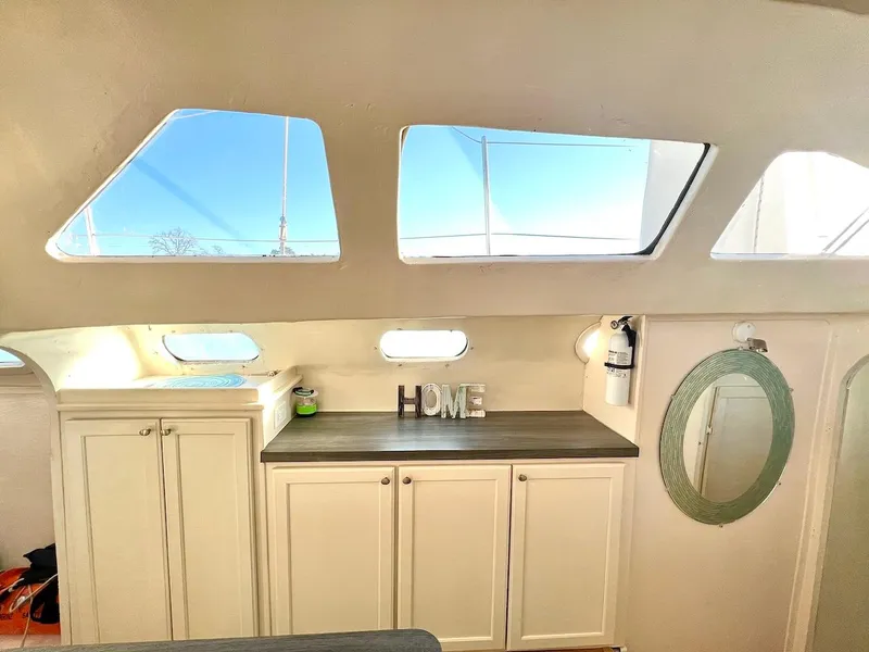 Slide: The Image of Interior of 2007 Farrier F-41 with white cabinets and large windows. - 22