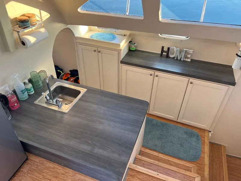 Slide: The Image of 2007 Farrier F-41 boat kitchen with sink, cabinets, and 'HOME' decor. - 23