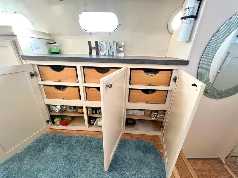 Slide: The Image of Cabinet with open doors revealing storage drawers and shelves in a 2007 Farrier F-41. - 24