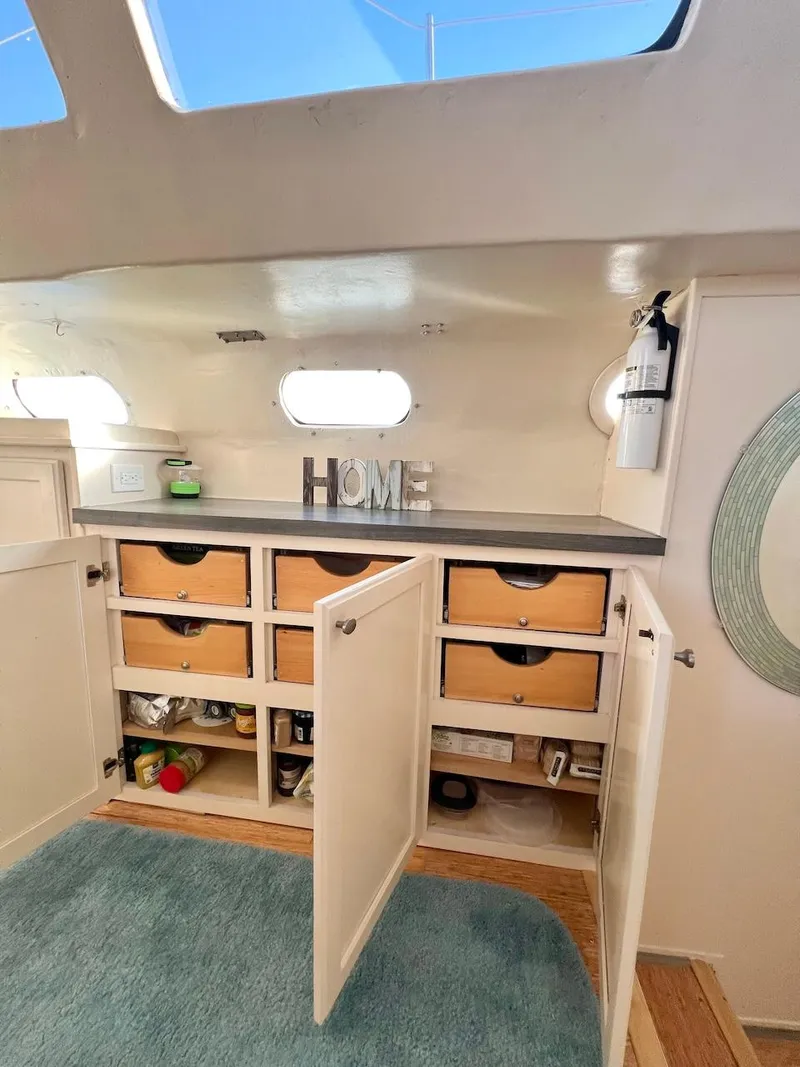 Slide: The Image of Interior of 2007 Farrier F-41 with open storage cabinets and HOME decor. - 25