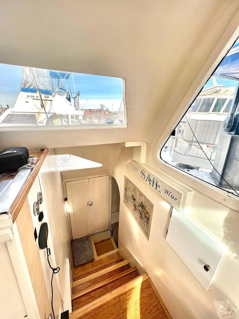 Slide: The Image of 2007 Farrier F-41 boat interior with wooden stairs and marina view. - 30