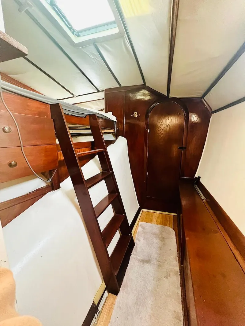 Slide: The Image of 2007 Farrier F-41 interior cabin with wooden ladder and storage. - 32