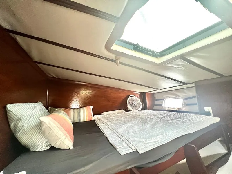 Slide: The Image of Cozy sleeping quarters in a 2007 Farrier F-41 sailboat with pillows and a fan. - 33