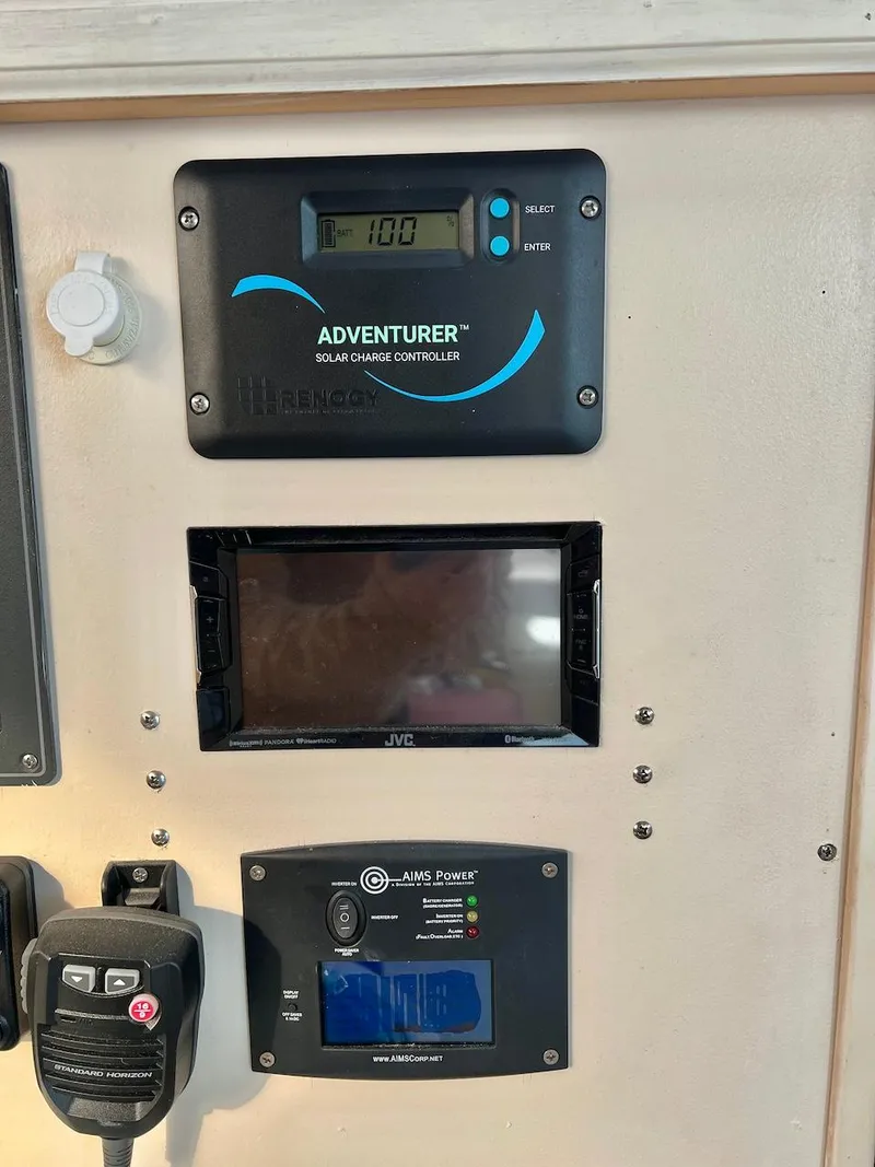 Slide: The Image of Control panel of a 2007 Farrier F-41 with solar charge controller and other devices. - 36