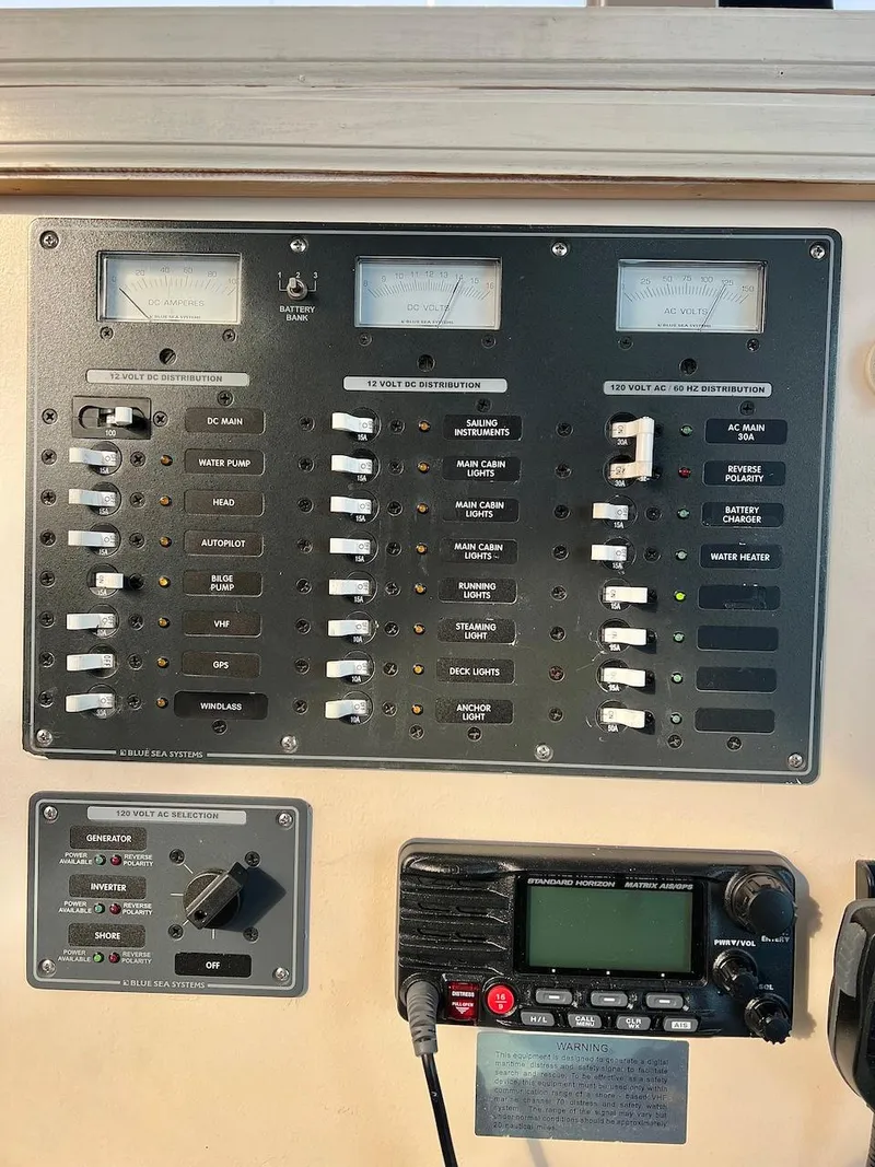 Slide: The Image of Control panel of a 2007 Farrier F-41 boat with various switches and a radio. - 37