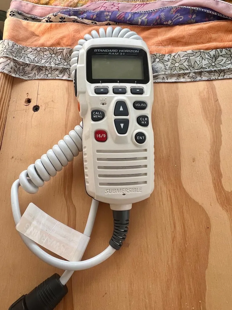 Slide: The Image of Handheld marine radio Farrier F-41, 2007 model, on wooden surface. - 38