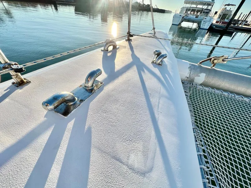Slide: The Image of Deck of 2007 Farrier F-41 catamaran with cleats and netting, docked at marina. - 4