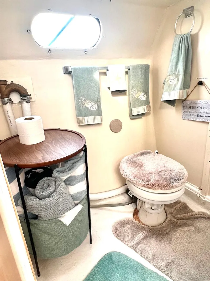 Slide: The Image of 2007 Farrier F-41 boat bathroom with toilet, towels, and storage basket. - 40
