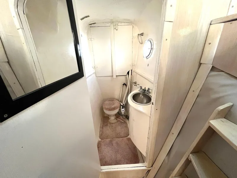 Slide: The Image of Compact bathroom in a 2007 Farrier F-41 boat with toilet, sink, and mirror. - 48